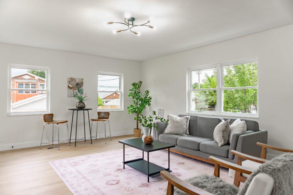 Living room with sofa, accent chairs, and wood floors