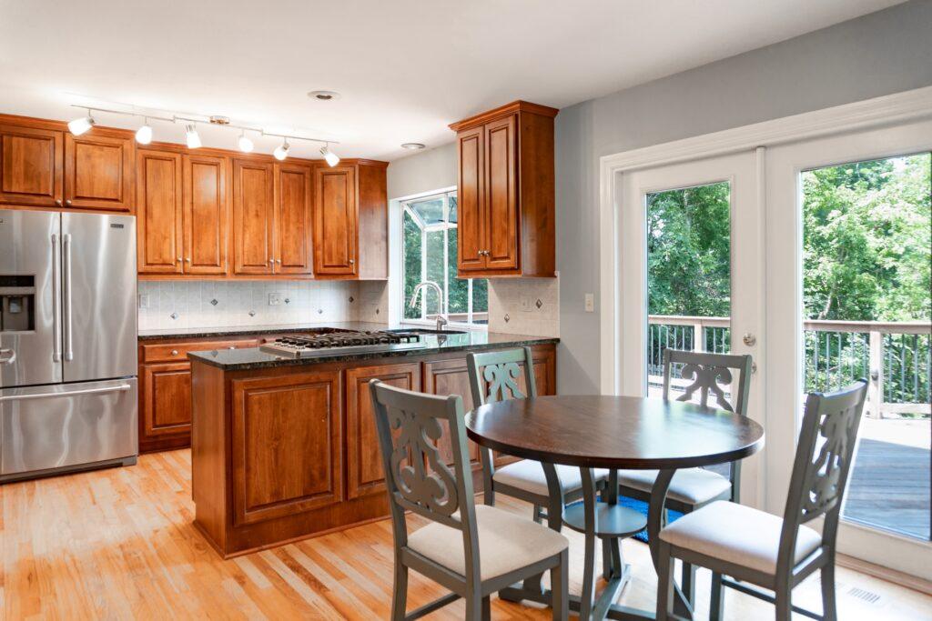 Kitchen with wood cabinets and small dining table