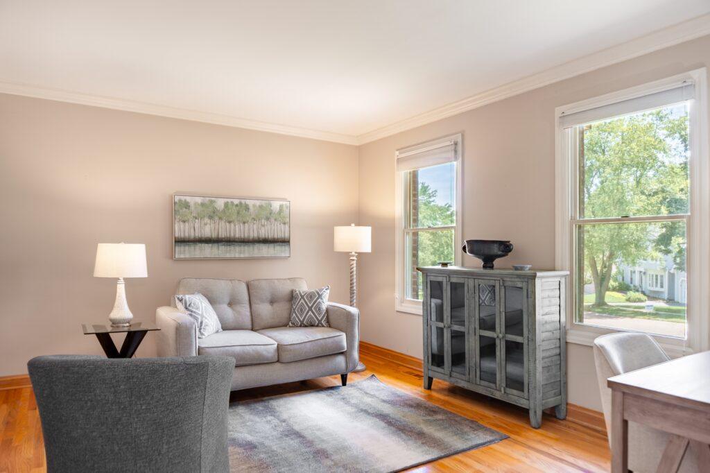 Sitting area with loveseat, side table, and window views