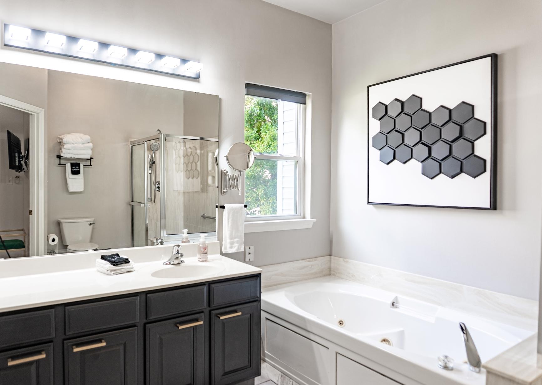 Bathroom with soaking tub, vanity, and modern fixtures