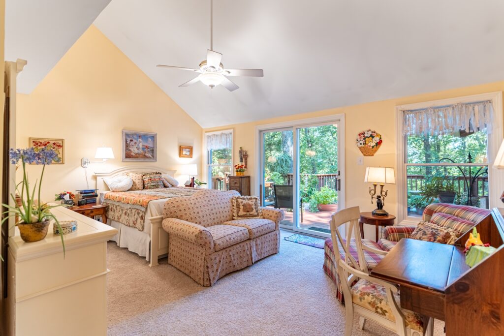 Living room with sofa seating, sliding doors, and backyard view