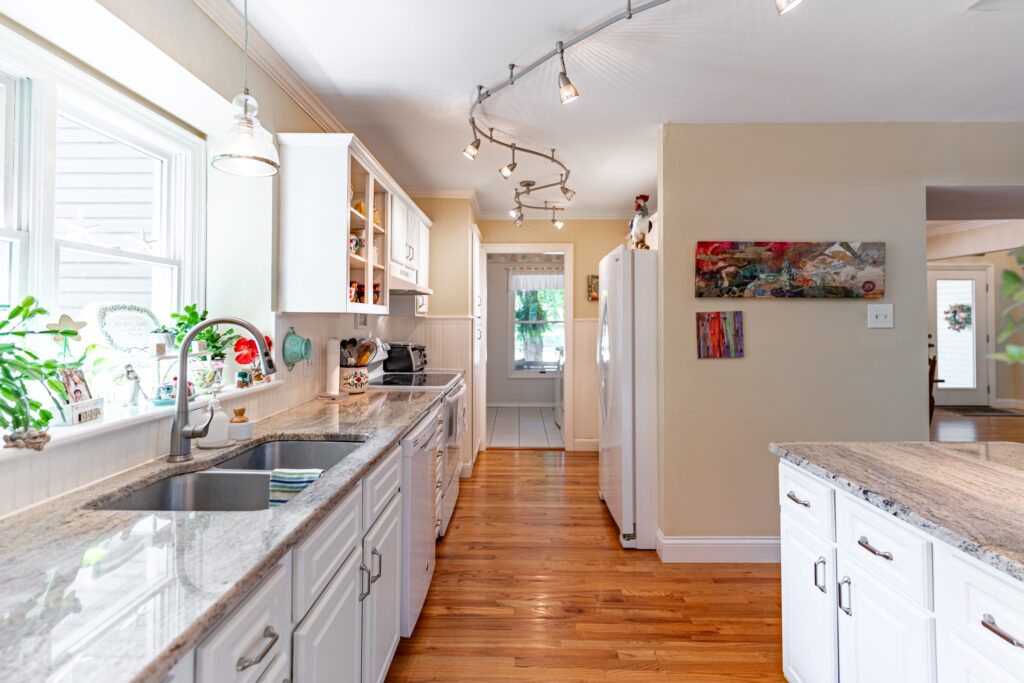 Bright kitchen with white cabinets and granite countertops