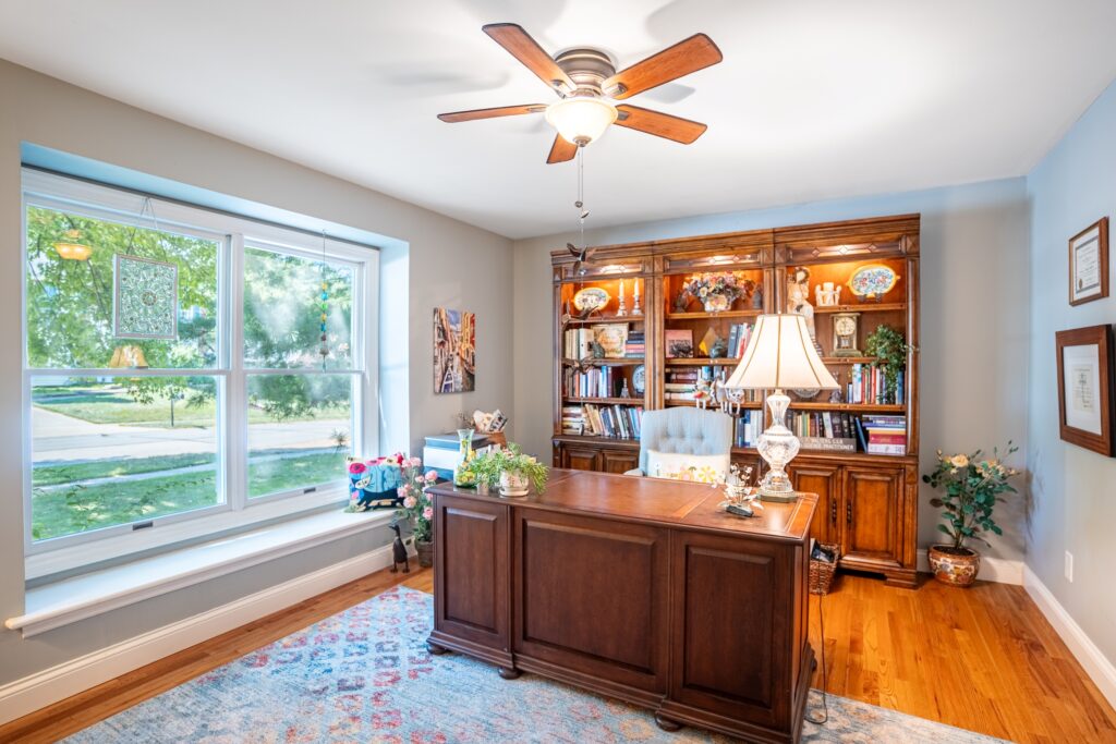 Living room with built-in wood cabinetry and large window