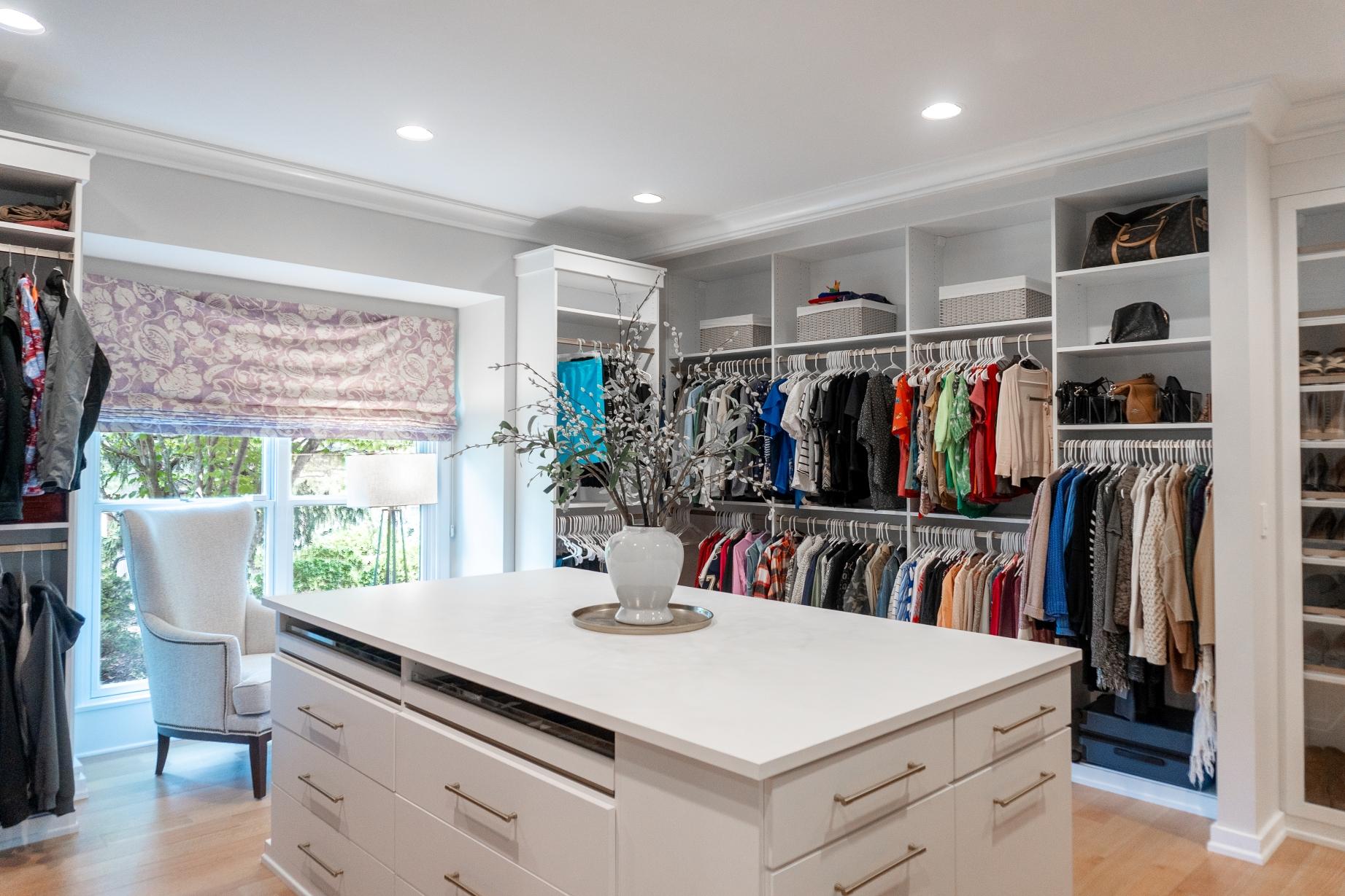 Walk-in closet with built-in shelving and clothing racks