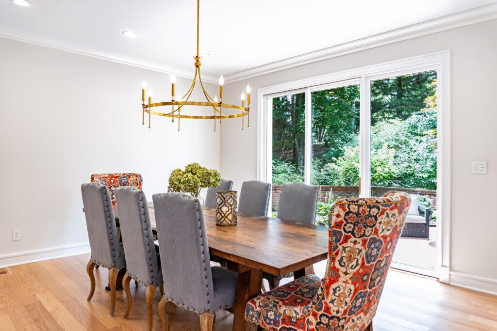 Dining room with gold chandelier and upholstered chairs