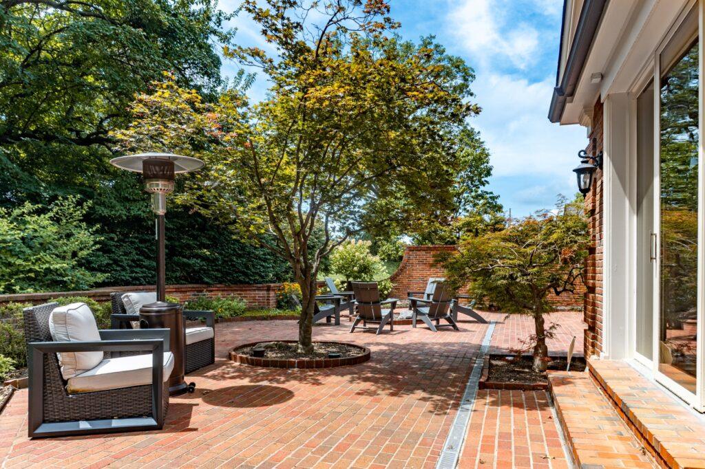 Backyard patio with dining table and trees