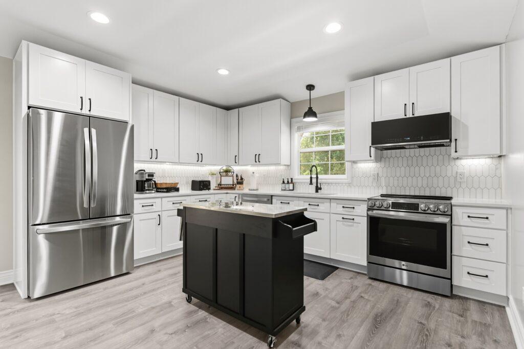 Modern kitchen with island, stainless steel appliances, and pendant lighting