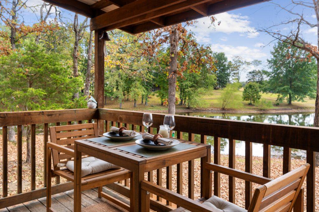 Covered porch with table seating overlooking lake