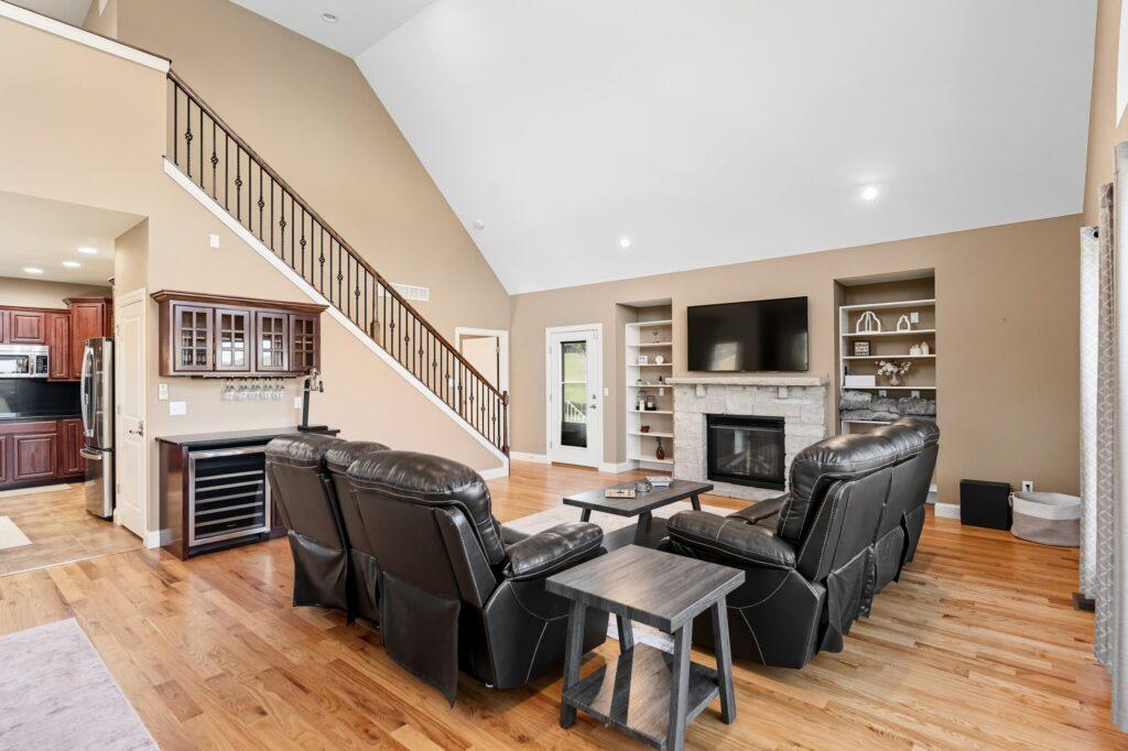 Living room with sectional sofas, hardwood floors, and built-in shelving