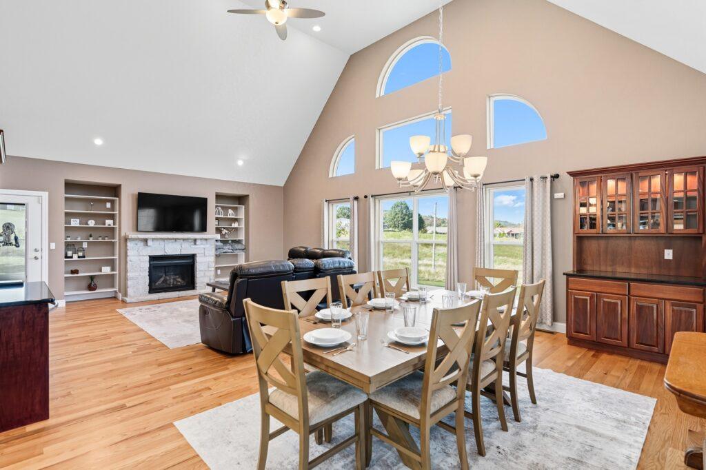 Open dining area with vaulted ceiling and large windows