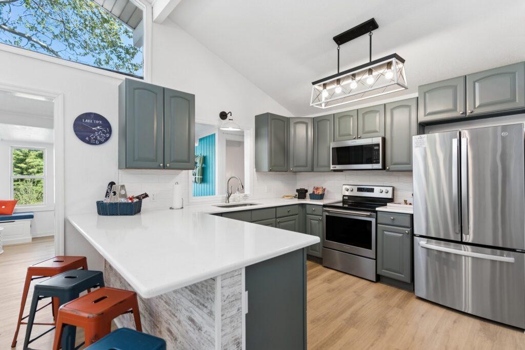 Kitchen with a breakfast bar and colorful stools