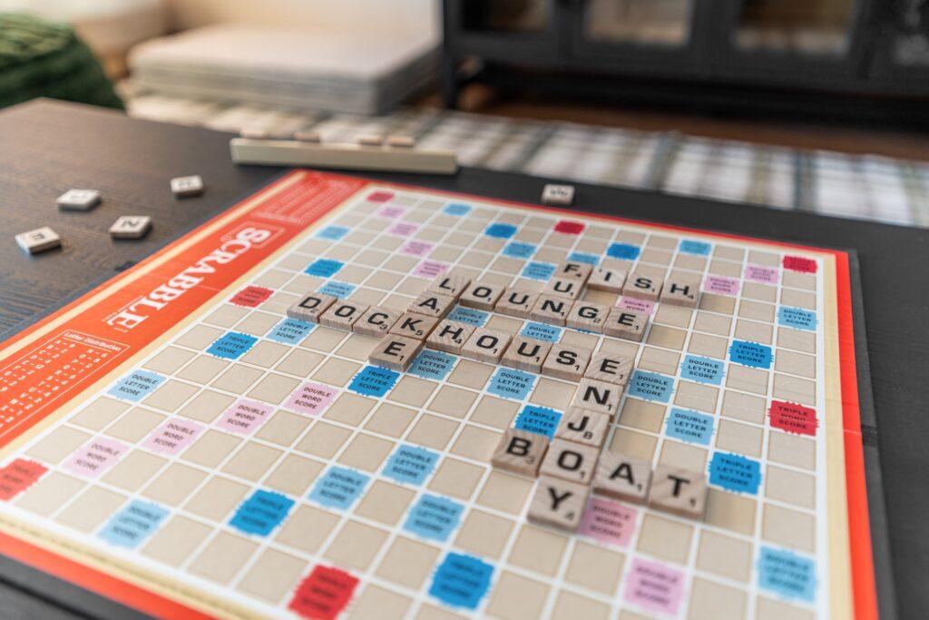 Scrabble board with various lake vacation related words spelled across it