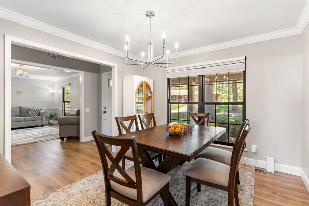 Dining room with windows and an un-set table for six