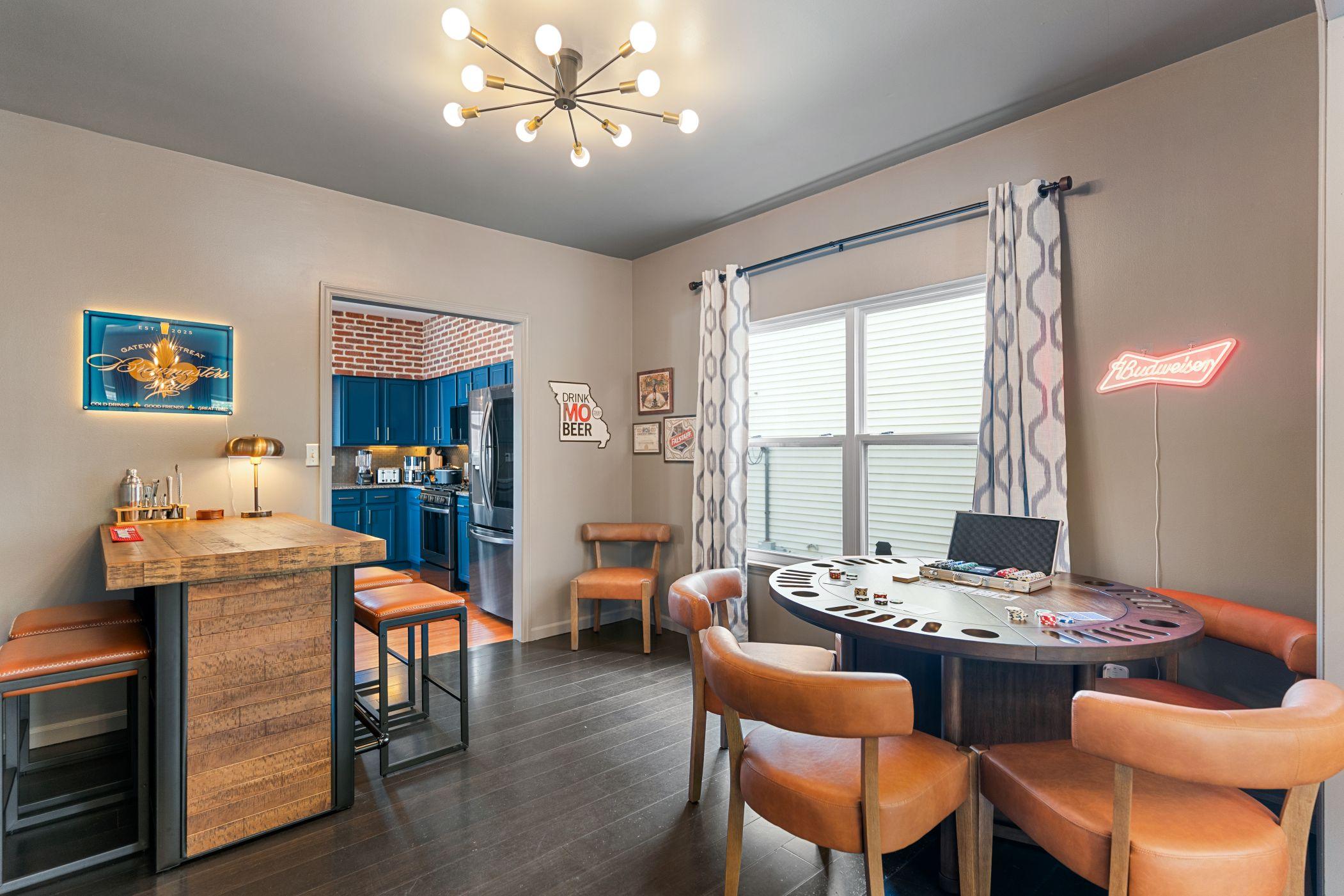 A game room featuring a small bar and a set poker table