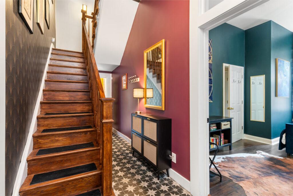 A wooden staircase with two hallways behind it
