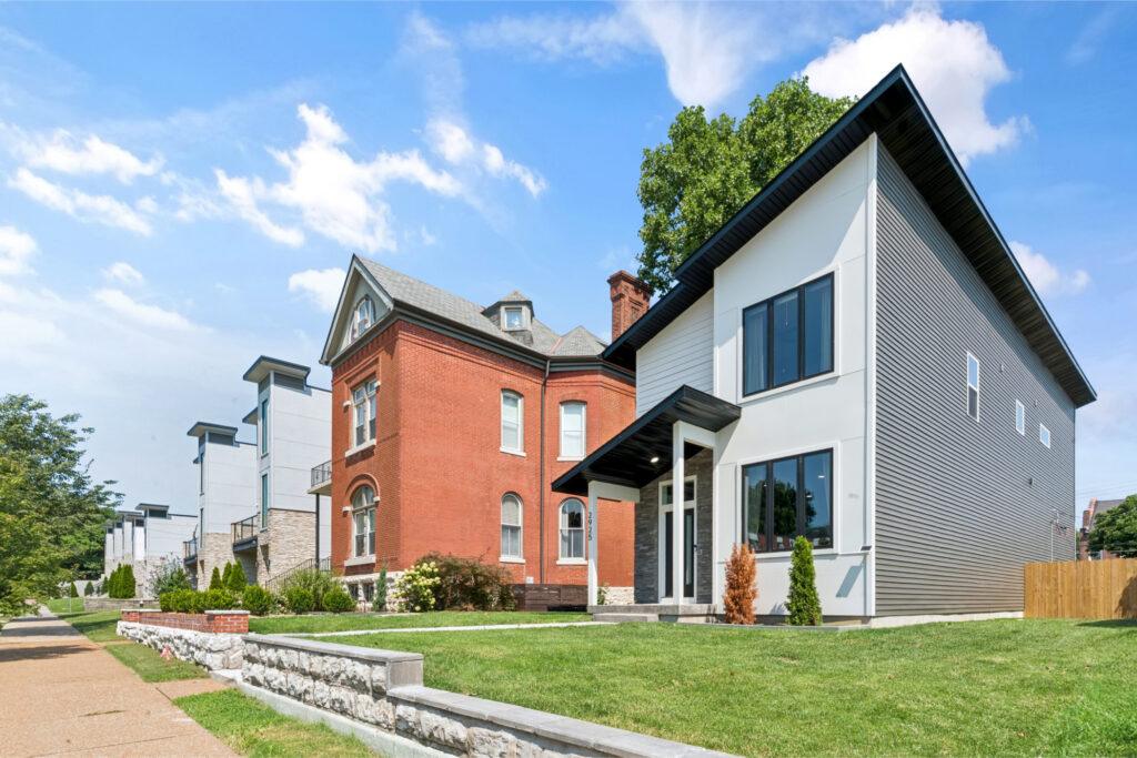 Exterior shot of a modern house with white siding and an angular roof